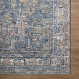 Close-up of Mirabel Denim Blue Traditional Rug showing its cream, blue, and brown oriental pattern and soft texture. Corner