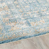 Close-up of the Mirabel Denim Blue Traditional Rug, showing its cream, tan, and blue oriental pattern and soft texture. Corner