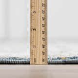 Close-up of the Mirabel Denim Blue Traditional Rug showing the pile height with a ruler. Pile