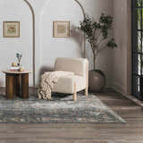 Living room scene with a Mirabel Denim Blue Traditional Rug, cream chair, and round side table. Roomscene-Rectangle