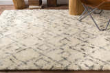 Close-up of a cream shag rug with a trellis pattern. The Cotgrave rug is made of wool and has a soft, textured feel. Styleshot