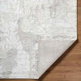 Close-up of the Chroma Abstract Cream Area Rug showing its abstract design, soft texture, and rug backing. Fold