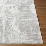 Close up of the Chroma Abstract Cream Area Rug showing its textured, light gray and ivory abstract design. Front