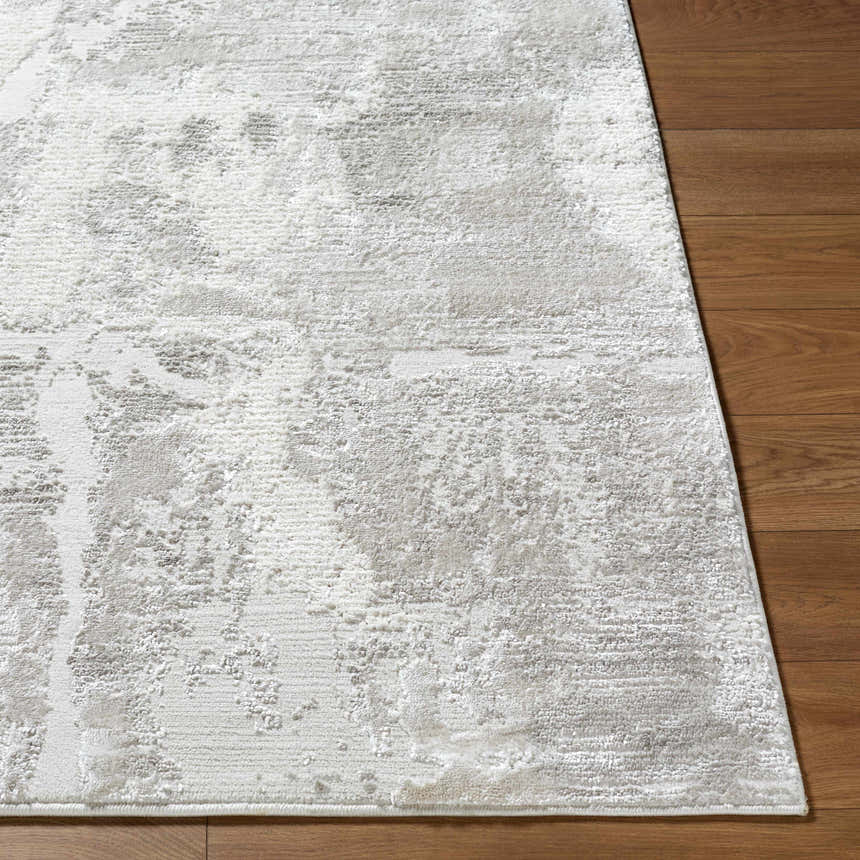 Close up of the Chroma Abstract Cream Area Rug showing its textured, light gray and ivory abstract design. Front