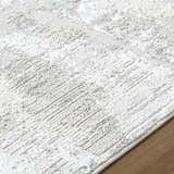 Close-up of the cream Chroma Abstract Area Rug showing its soft texture and subtle ivory and gray contemporary pattern. Texture