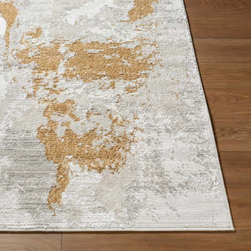Close-up of the Chroma Area Rug showing its ivory, gray, white, and mustard contemporary design and soft texture. Front