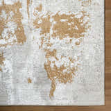 Close-up of the Chroma Area Rug. Contemporary design in ivory, light gray, and mustard colors. Machine woven texture. Corner