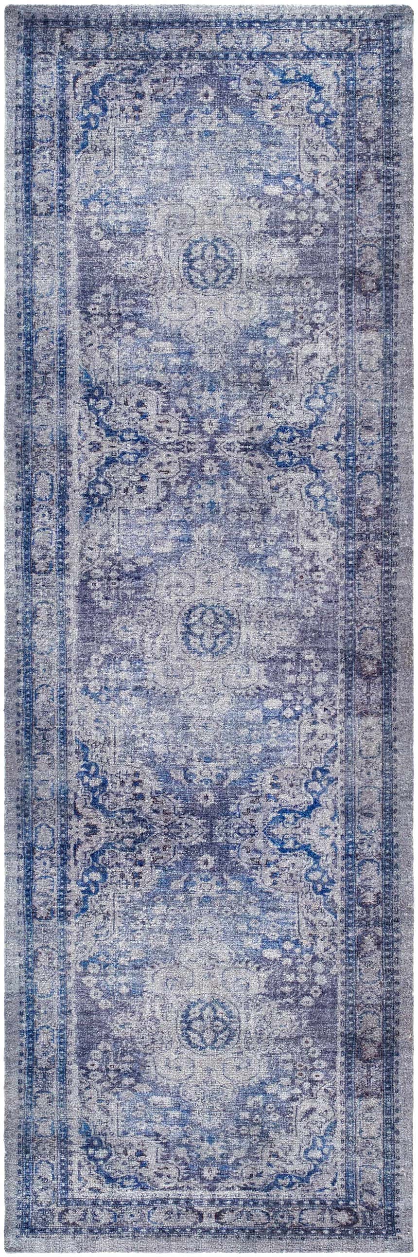 Close-up of the Csilla Area Rug. Hand-tufted polyester rug in arctic sky, blue, ivory, and slate blue with a traditional pattern. Design-Runner-268