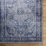 Close up of the hand tufted Csilla Area Rug. Traditional design in arctic sky, blue, and ivory. Corner