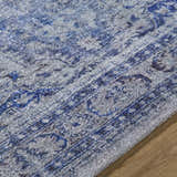 Close-up of the Csilla Area Rug showing its traditional blue and ivory pattern and hand-tufted texture. Texture