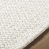 Close-up of the textured weave of the Cqasce Navy Solid Hand Woven Wool Area Rug showing its chunky, hand-woven wool detail. Texture