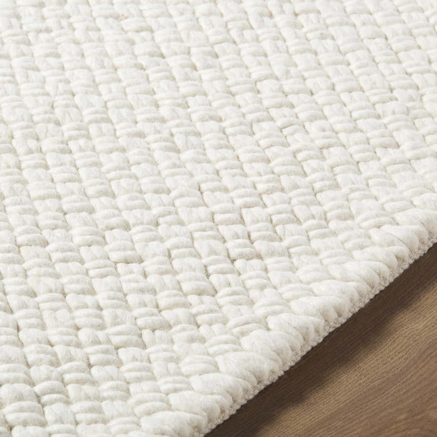 Close-up of the textured weave of the Cqasce Navy Solid Hand Woven Wool Area Rug showing its chunky, hand-woven wool detail. Texture