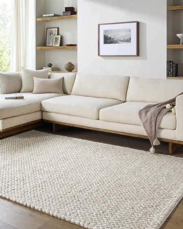 Living room scene with ivory sectional sofa and Rowue Ivory Solid Hand Woven Wool Area Rug. Farmhouse style. Roomscene-Rectangle