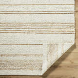 Close-up of the hand-woven Ciaran Area Rug. Ivory wool rug with sandstone stripes and a textured, transitional design. Fold
