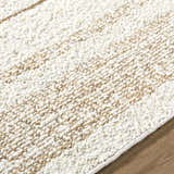 Close-up of the hand woven Ciaran Area Rug. Ivory and sandstone wool with a subtle striped pattern. Texture
