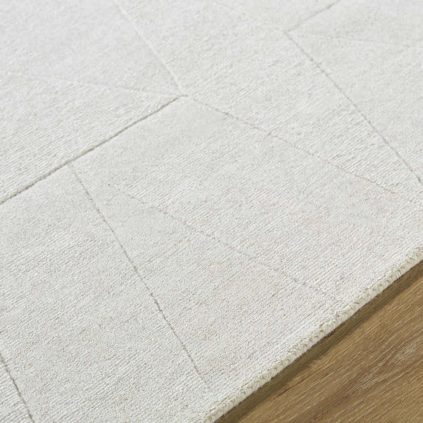 Close up of the ivory Callie Area Rug, showing the geometric pattern and hand loomed wool texture. Texture