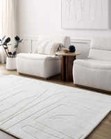 Living room scene with off-white Camryn Area Rug, two armchairs, side table, and minimalist art. Roomscene-Rectangle