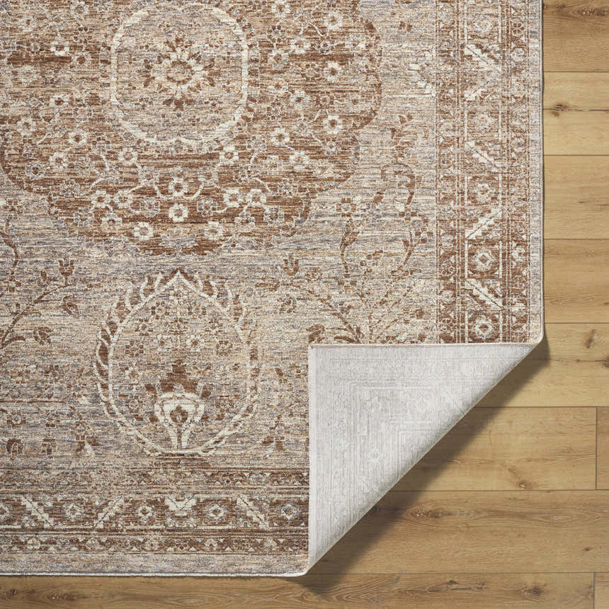 Close-up of the Cosimo Area Rug revealing its cream, dark red, gray, and tan traditional pattern and machine-woven texture. Fold