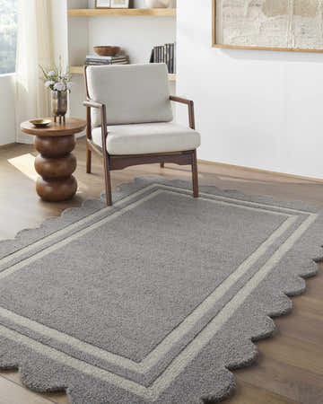 Living room scene with a Chogan Slate Gray Area Rug, chair, side table, and wood floors. Roomscene-Rectangle