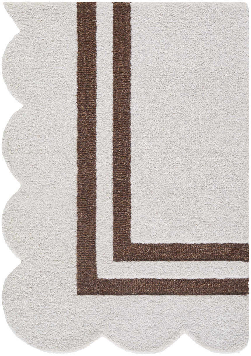 Close-up of the hand-tufted Chogan Ivory Area Rug. Features a brown border and a unique scalloped edge. 100% Wool. Corner