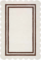 Close-up of the hand-tufted Chogan Ivory Area Rug with a brown border and scalloped edges. Design-Rectangle-576
