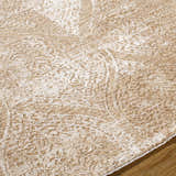 Close-up of the Cariel Beige Area Rug showing its traditional, textured pattern and soft tan and prairie dust colors. Texture