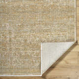 Close-up of the Becki Taupe Owens x Livabliss Renaissance Area Rug, a wool rug with a traditional beige and taupe pattern. Fold