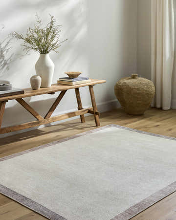 Entryway with beige Olympic Border Area Rug, wood bench, vases, and woven basket for a farmhouse feel. Roomscene-Rectangle