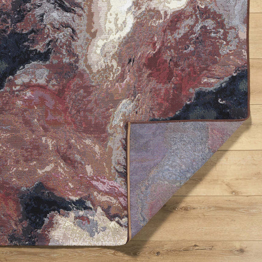 Close-up of the Chemed Area Rug showing charcoal, crimson, ivory, and mustard colors with a coastal-inspired abstract pattern. Fold