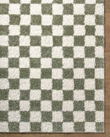 Close-up of the Castagnito Area Rug. Features a contemporary checkerboard pattern in cream and sage green. Soft, textured pile. Corner