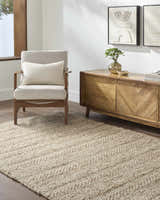 Living room scene with a Ctadqe Beige Stripe Hand Woven Wool Area Rug, chair, and wood cabinet. Farmhouse style. Roomscene-Rectangle