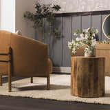 Living room scene with a Clarke Textured Braided Stripe rug, brown leather chair, and wood accent table. Roomscene-Rectangle