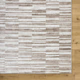 Close-up of Cemach Light Brown Area Rug with a contemporary geometric pattern in light brown and white. Swatch