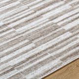 Close up of the Cemach Light Brown Area Rug featuring a contemporary stripe pattern in light brown and white. Texture