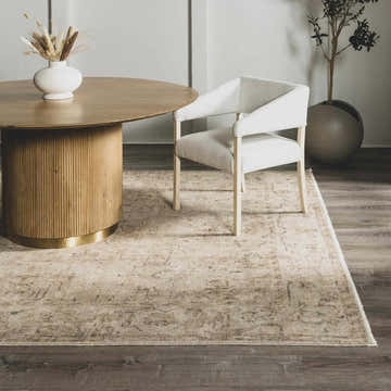 Dining room scene with round wood table and Fetscher I Vintage Medallion Area Rug in light brown, olive, and peach tones. Roomscene-Rectangle