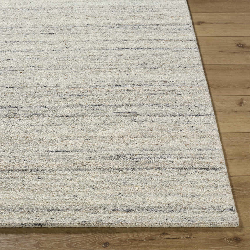 Close up of the Capote Ivory Area Rug showing wool texture and charcoal, tan, and taupe stripes. Front