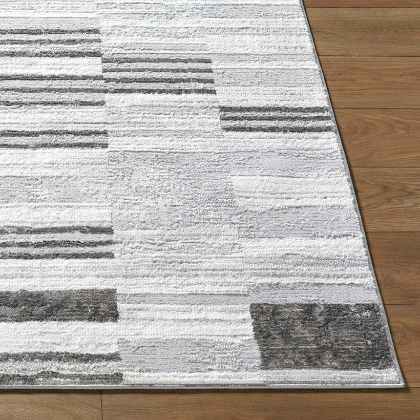 Close-up of the Chiaki Light Gray Area Rug showing its ivory, light gray, and medium gray geometric pattern. Front