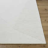 Close up of the ivory Carpus Area Rug showing its geometric pattern and subtle texture on hardwood floor. Front