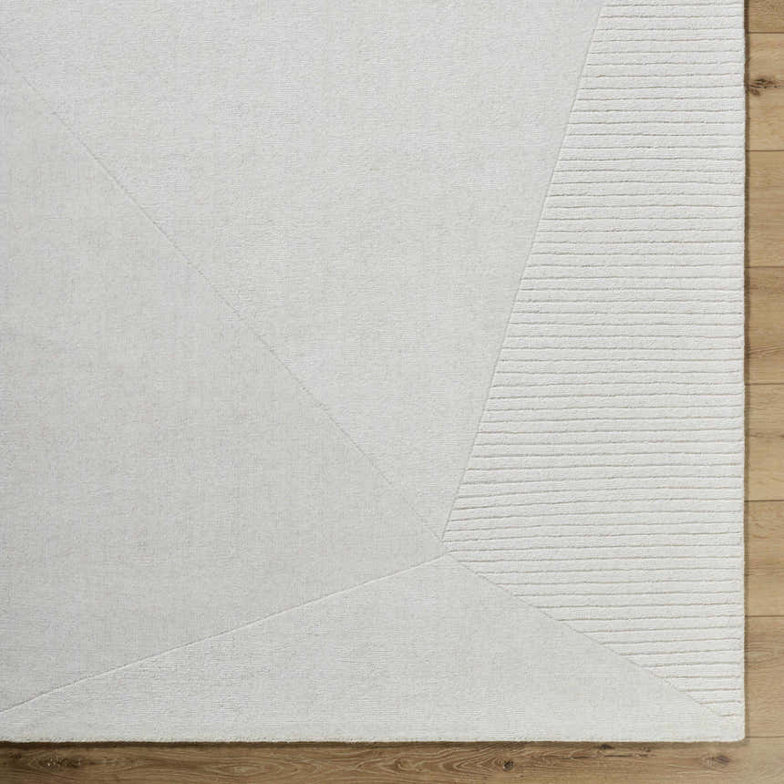 Close up of the Carpus Area Rug, ivory wool with geometric and striped design. Corner