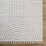 Close-up of the Cassie Area Rug; cream and peach rug with a geometric pattern. Corner