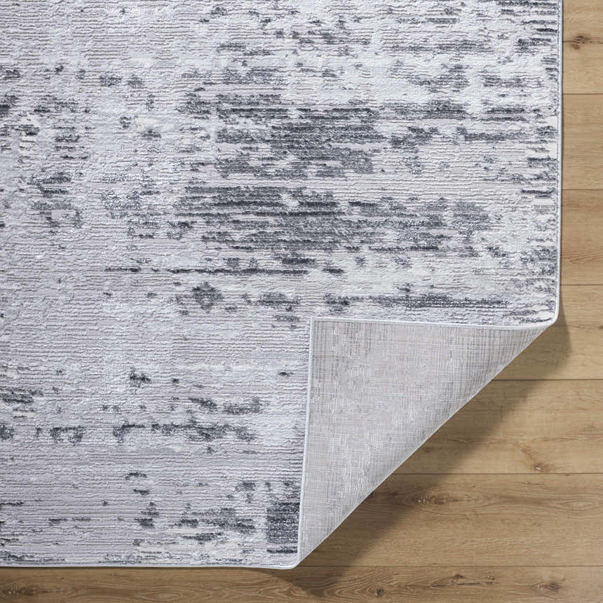 Close-up of the Candie Gray Area Rug showing its cream, ivory, and light gray contemporary pattern and texture. Fold
