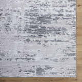 Close-up of Candie Gray Area Rug. Cream, ivory, light gray, and navy abstract pattern. Contemporary style. Corner