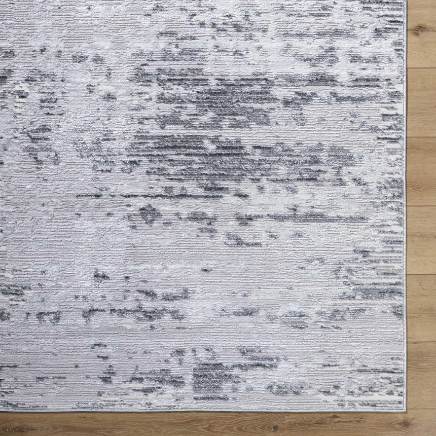 Close-up of Candie Gray Area Rug. Cream, ivory, light gray, and navy abstract pattern. Contemporary style. Corner