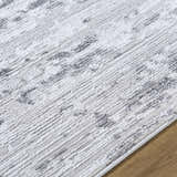 Close up of the Candie Gray Area Rug showing its cream, ivory, and light gray contemporary design. Texture