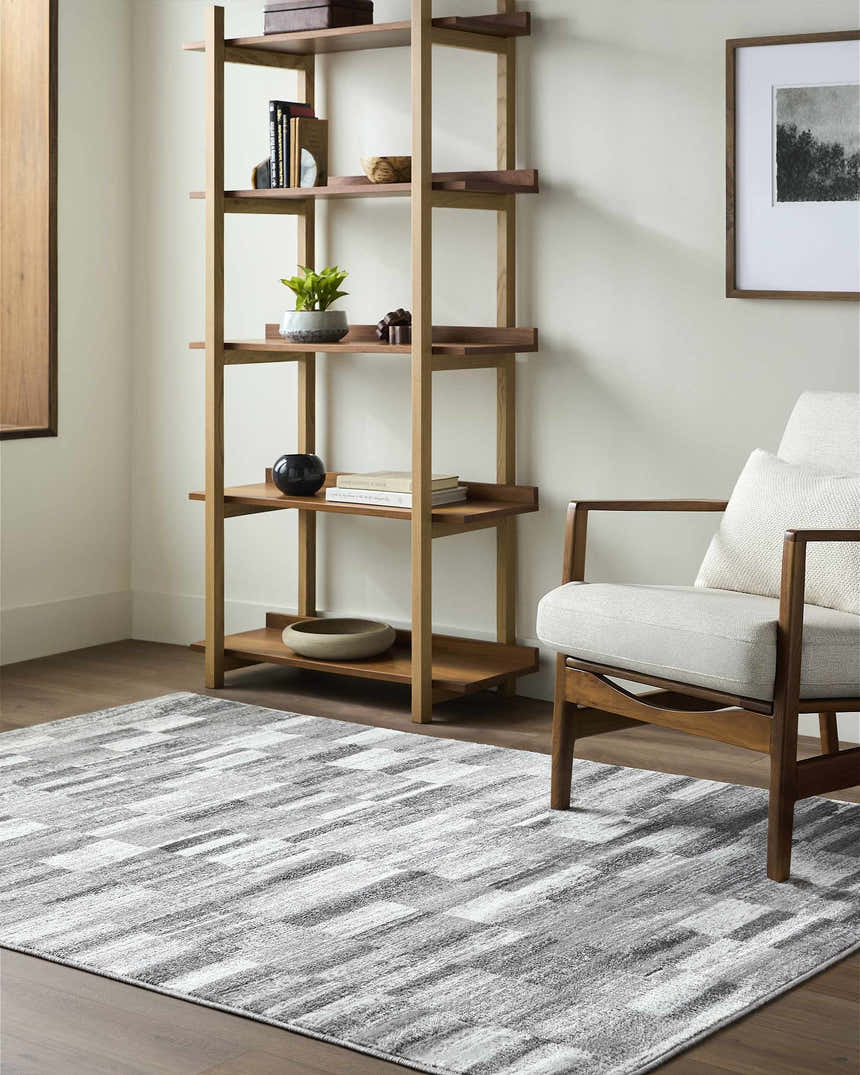 Living room scene with a gray Cherie area rug, wood shelving unit, and mid-century modern chair. Roomscene-Rectangle