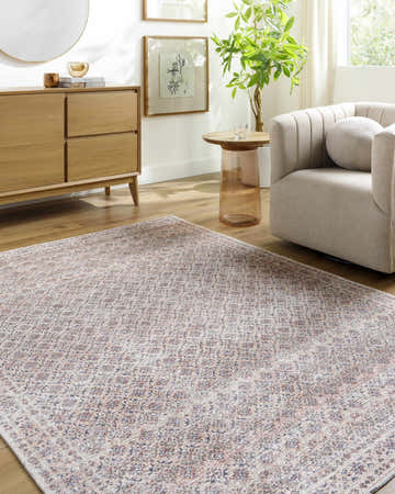 Living room scene with beige Agrata Washable Area Rug, light wood dresser, and neutral armchair. Farmhouse style. Roomscene-Rectangle
