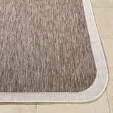 Close-up of Chetan Dark Brown Area Rug showing cream border and textured dark brown and cream weave. Front