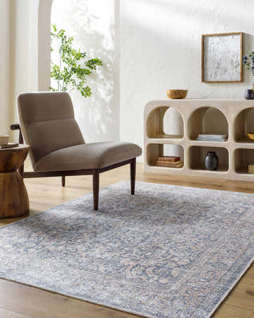 Living room scene with gray chair and beige, gray Chicha Washable Area Rug. Farmhouse style with wood accents. Roomscene-Rectangle