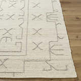 Close up of the hand woven Chanda Area Rug showing the beige wool texture and geometric design. Front