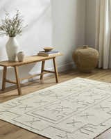 Neutral living room with wood bench and beige Chanda Area Rug featuring a geometric design. Roomscene-Rectangle